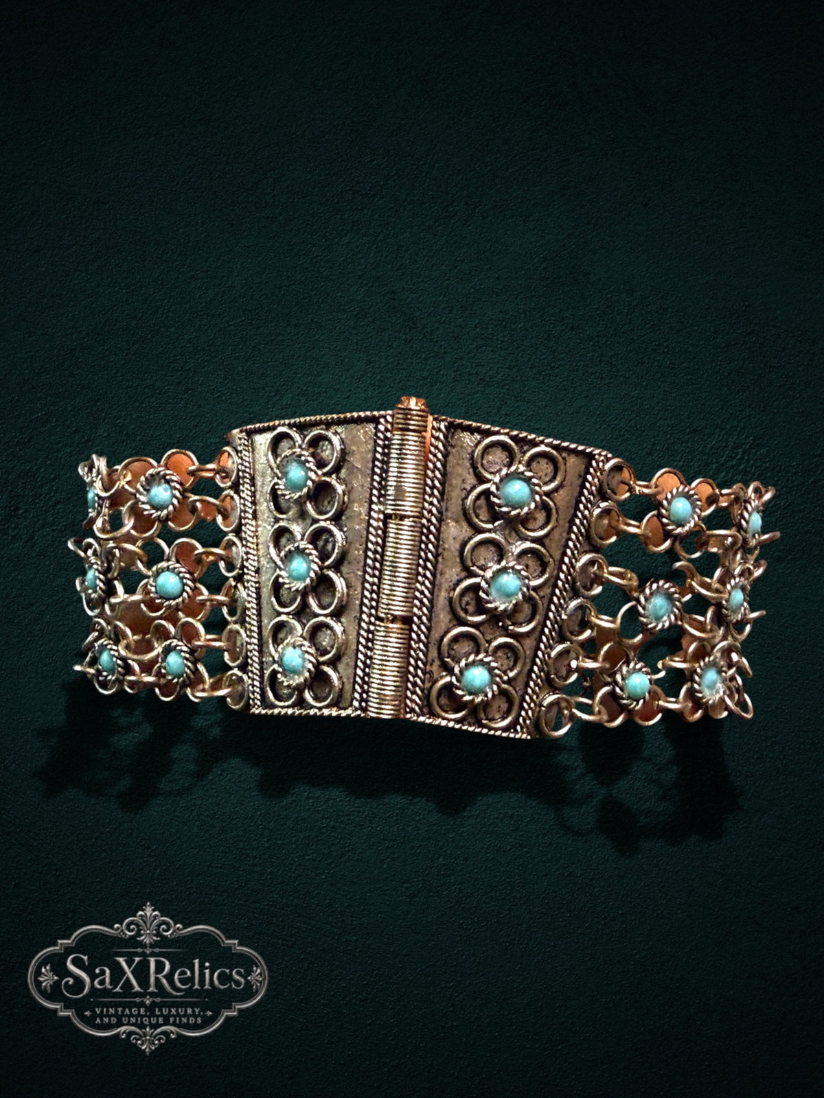 SaX Relics ornate link bracelet featuring antiqued metal, intricate rope-style details, and robin-egg blue stones.