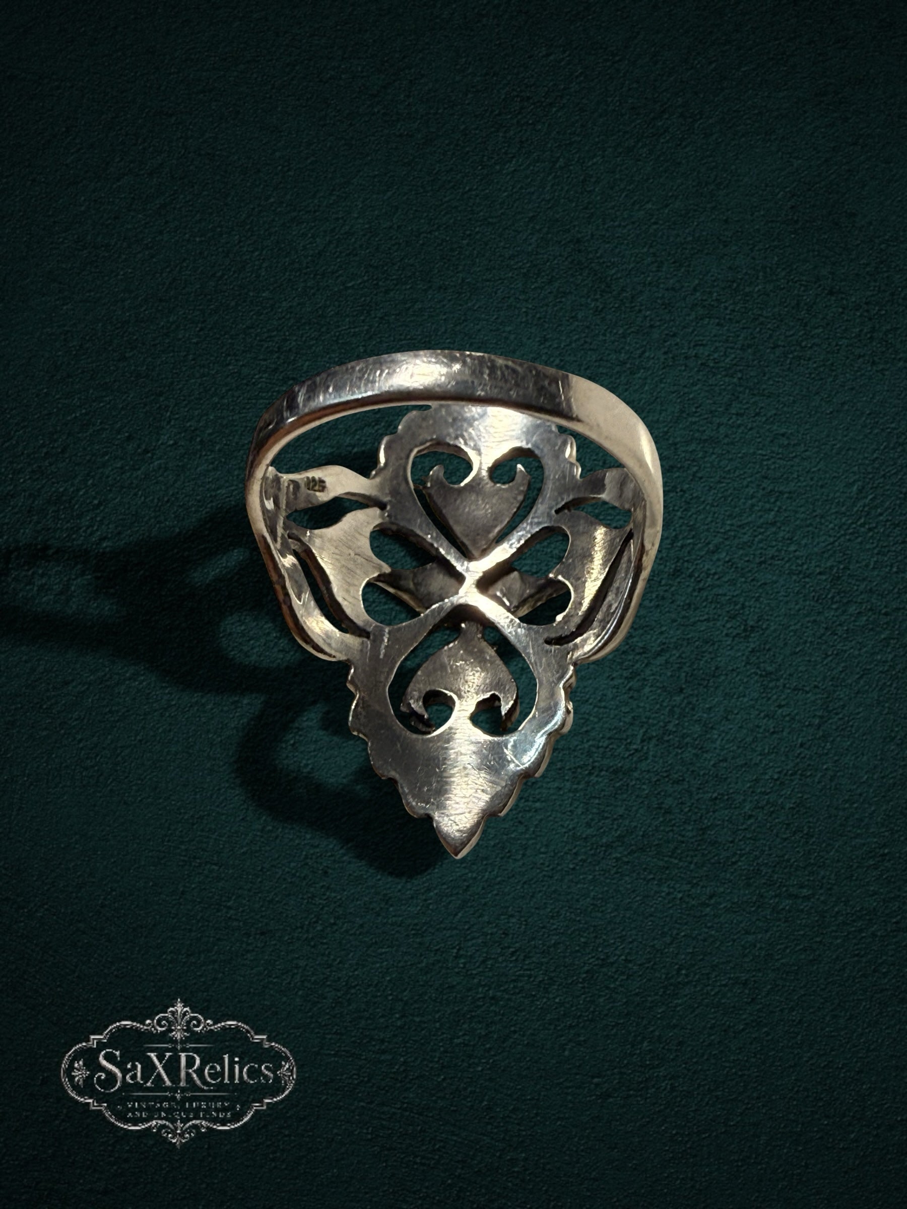 My Store SaxRelics ornate sterling silver statement ring featuring an intricate filigree heart design on a dark background