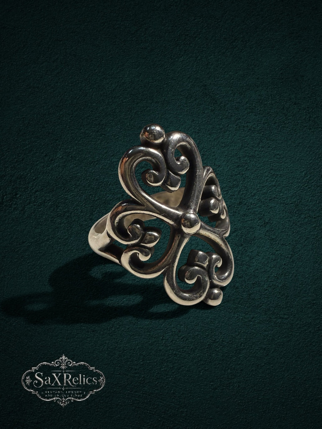 My Store SAXRelics sterling silver ring featuring an ornate quatrefoil filigree design with a polished finish.