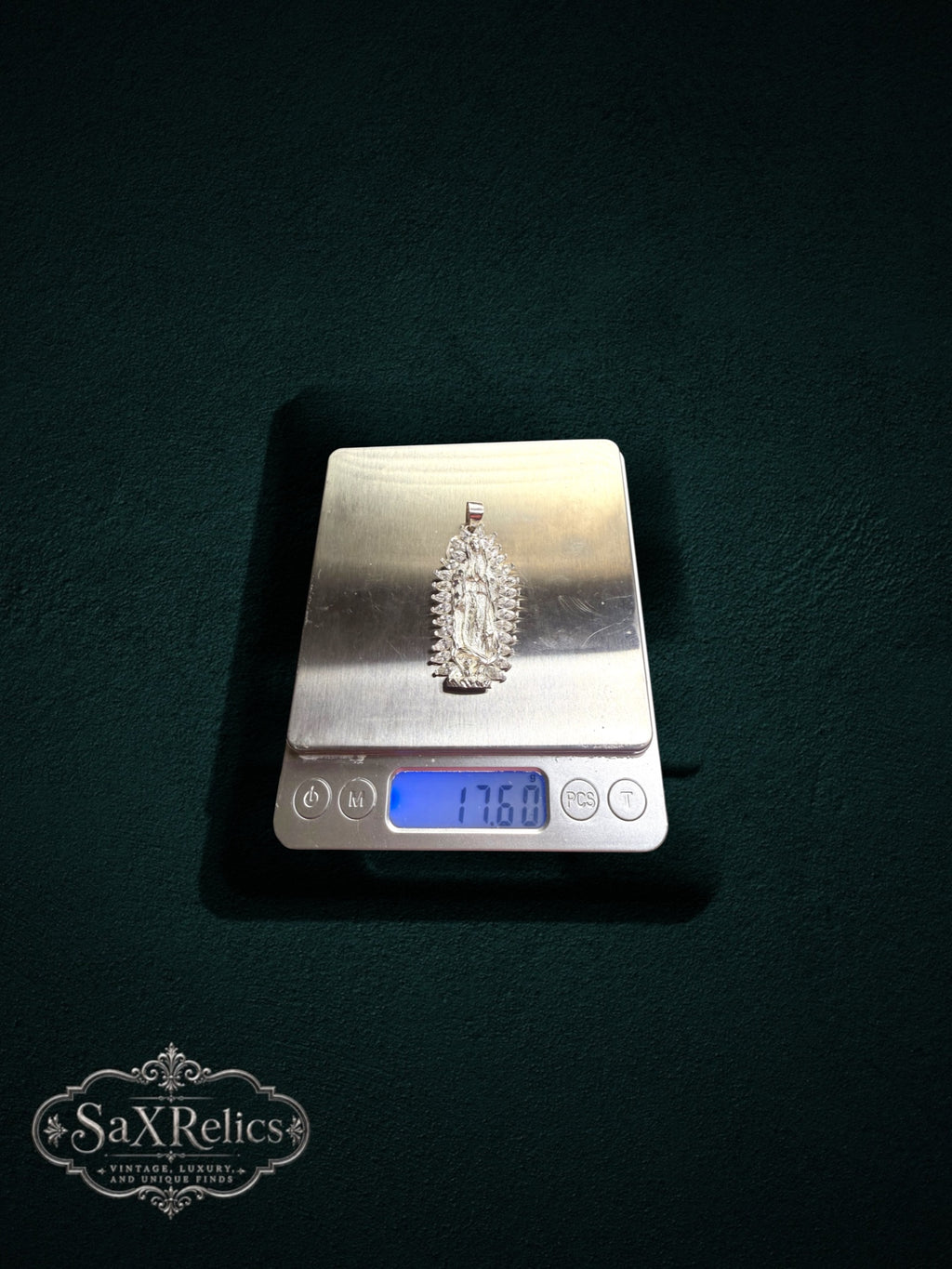 My Store Our Lady of Guadalupe silver pendant on a digital scale showing 17.60 grams weight