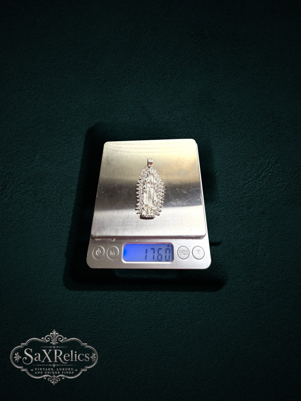 My Store Our Lady of Guadalupe silver pendant on a digital scale showing 17.60 grams weight