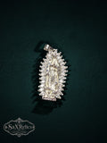 My Store Our Lady of Guadalupe silver-tone pendant with a halo of marquise-cut stones on a dark green background.