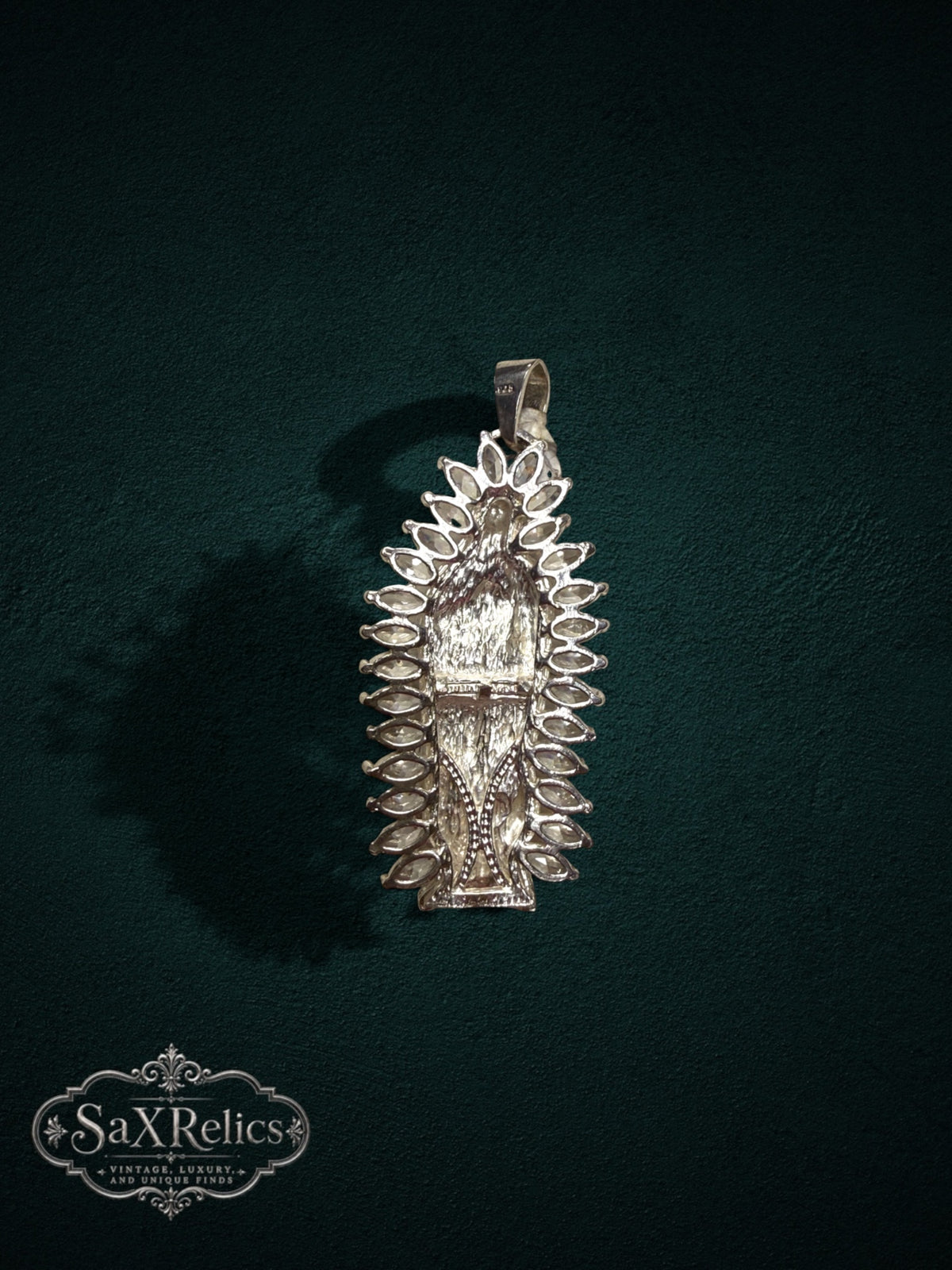 My Store Our Lady of Guadalupe silver-tone pendant with marquise-cut stone halo on a dark green background