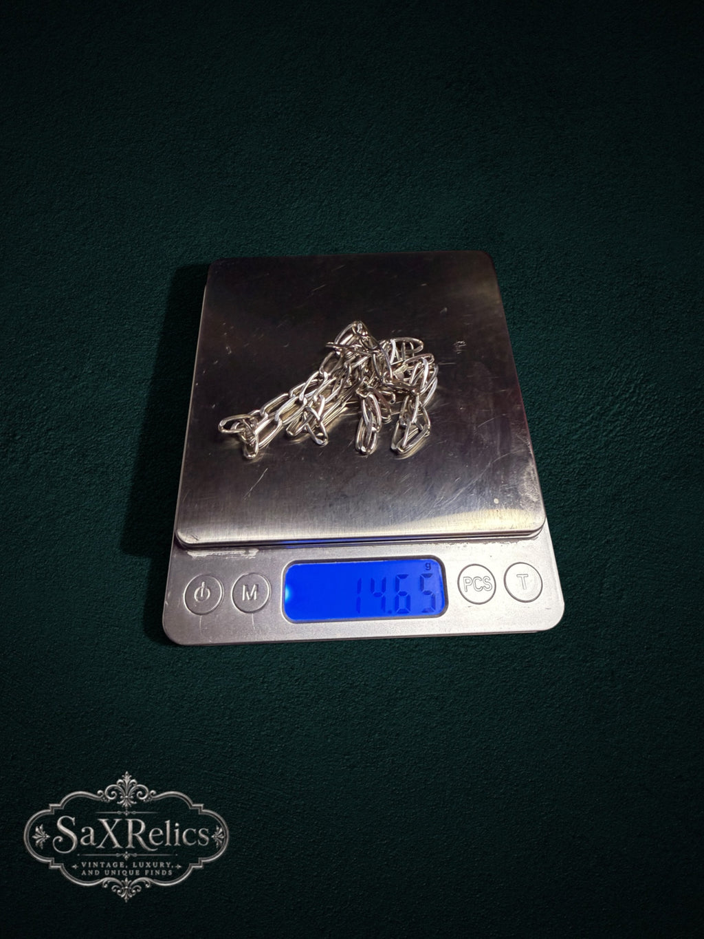 Presilla paperclip chain weighing 14.65 grams on a scale