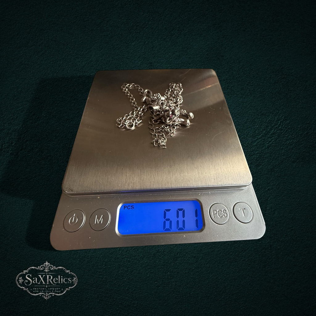 SaX Relics — Pantera sterling silver panther pendant necklace on a digital scale at 12.04 grams.