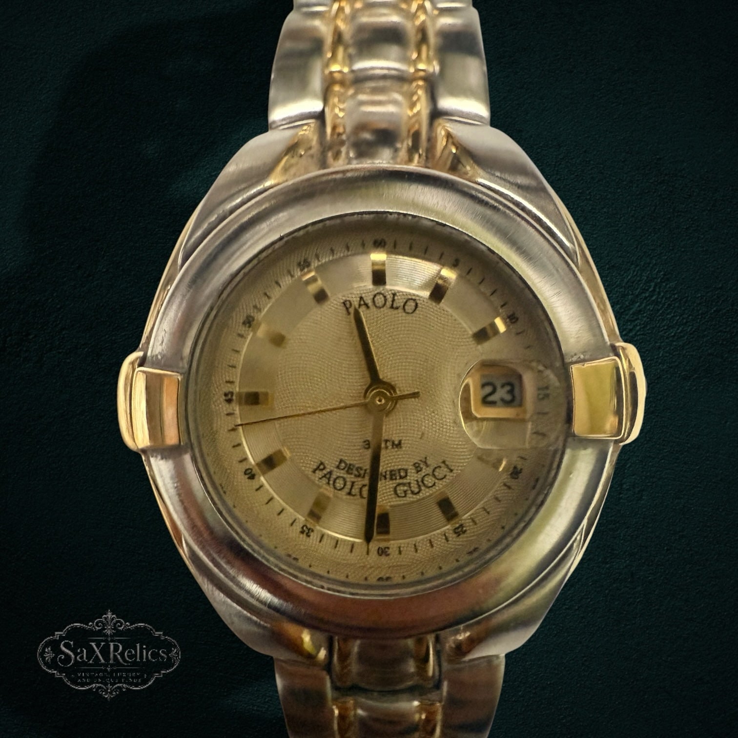 My Store PAOLO Designed By PAOLO GUCCI two-tone stainless steel wristwatch with a textured gold dial and date window.