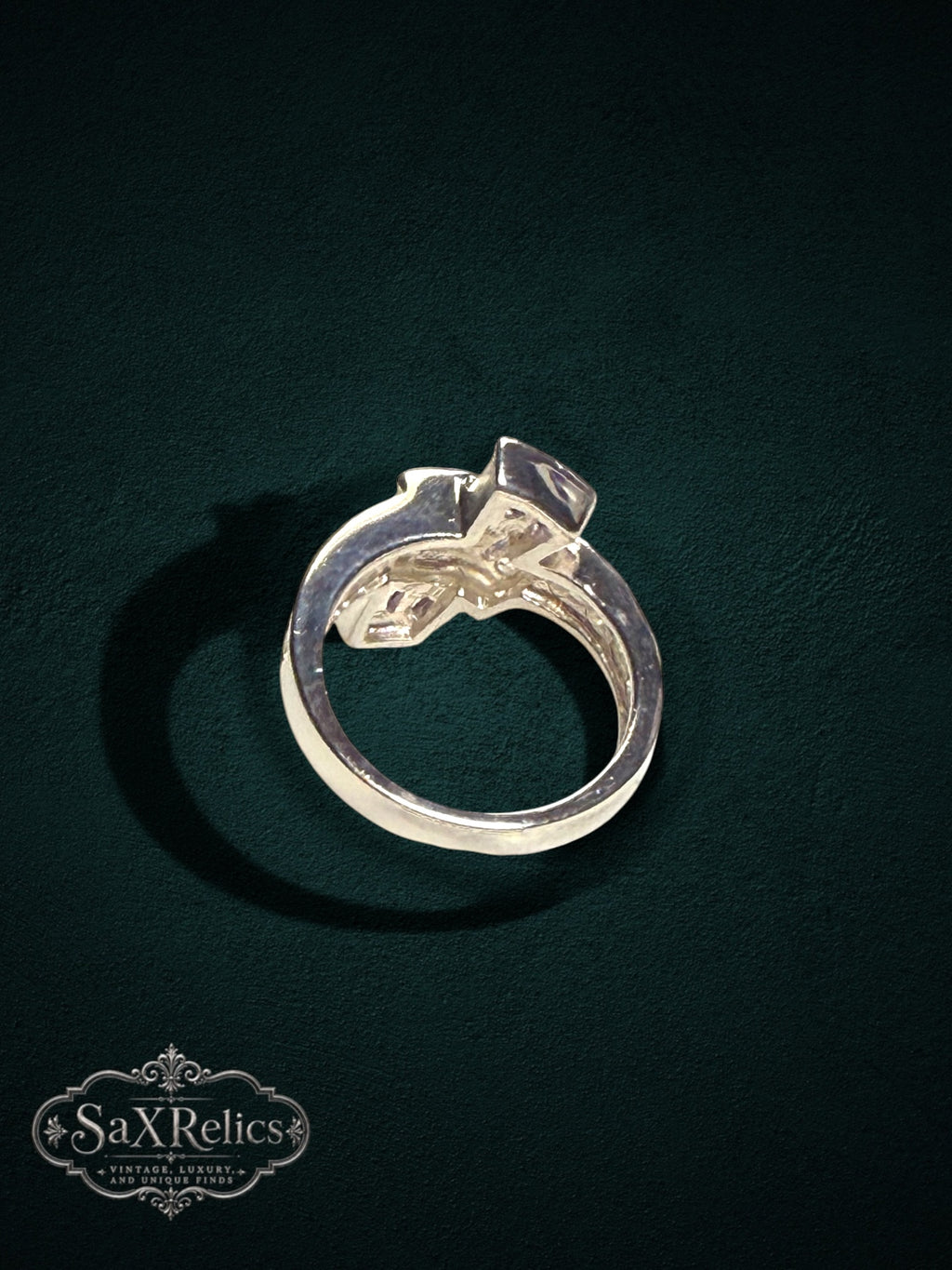 My Store statement ring featuring baguette-cut purple stones and clear accents on a polished metal band