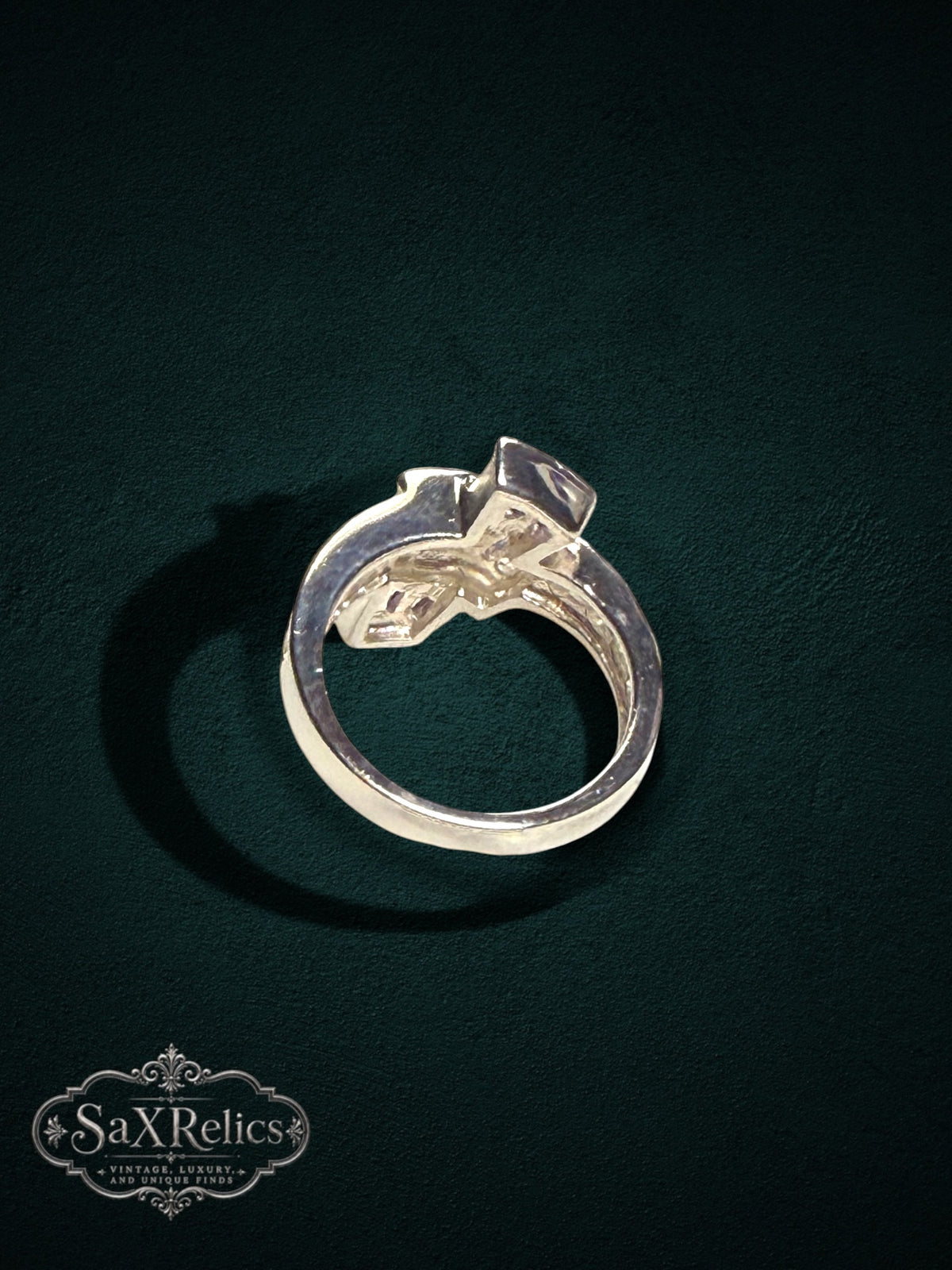My Store statement ring featuring baguette-cut purple stones and clear accents on a polished metal band