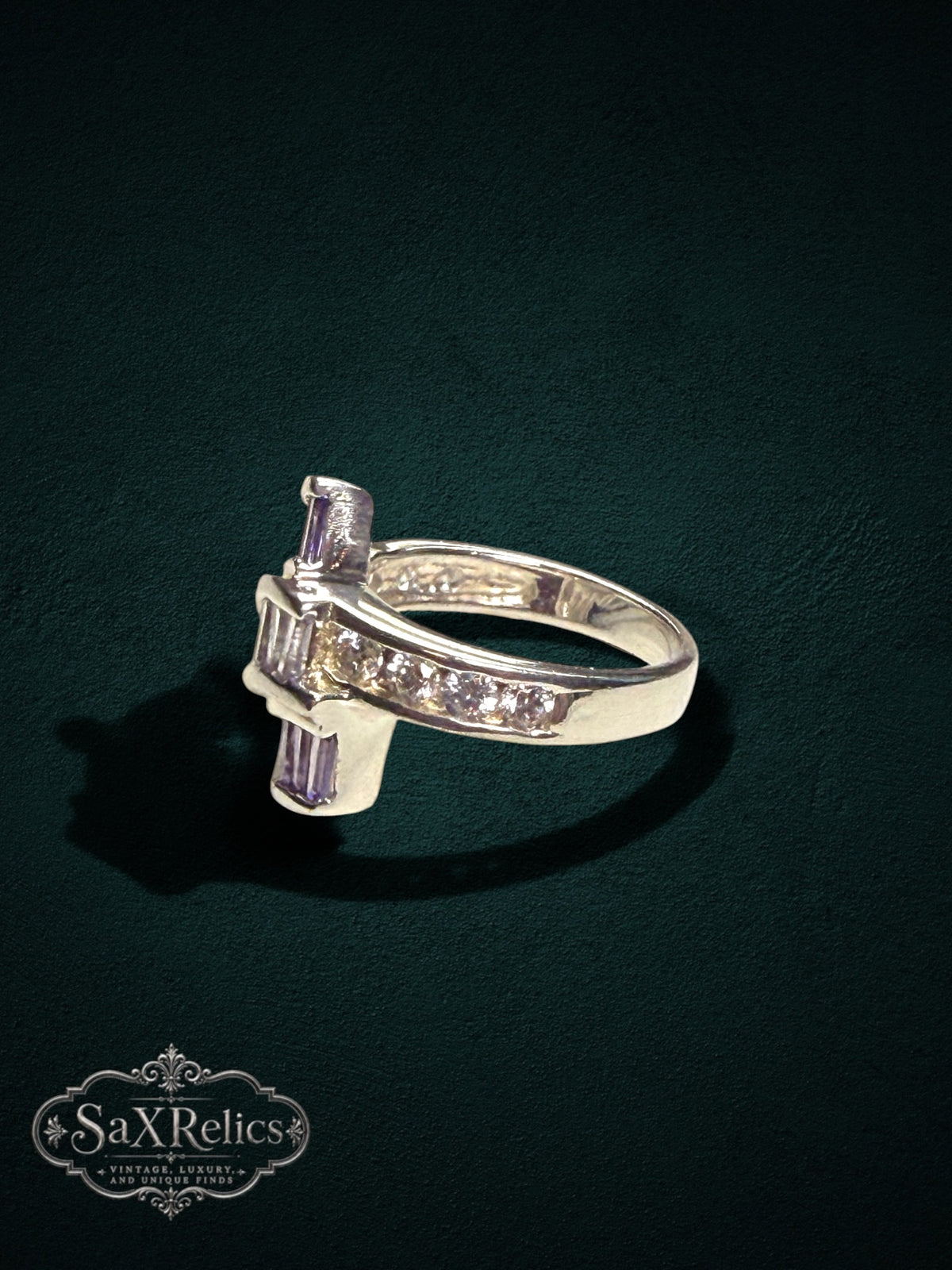 My Store statement ring featuring baguette-cut purple stones and clear accent stones on a polished silver-tone band.