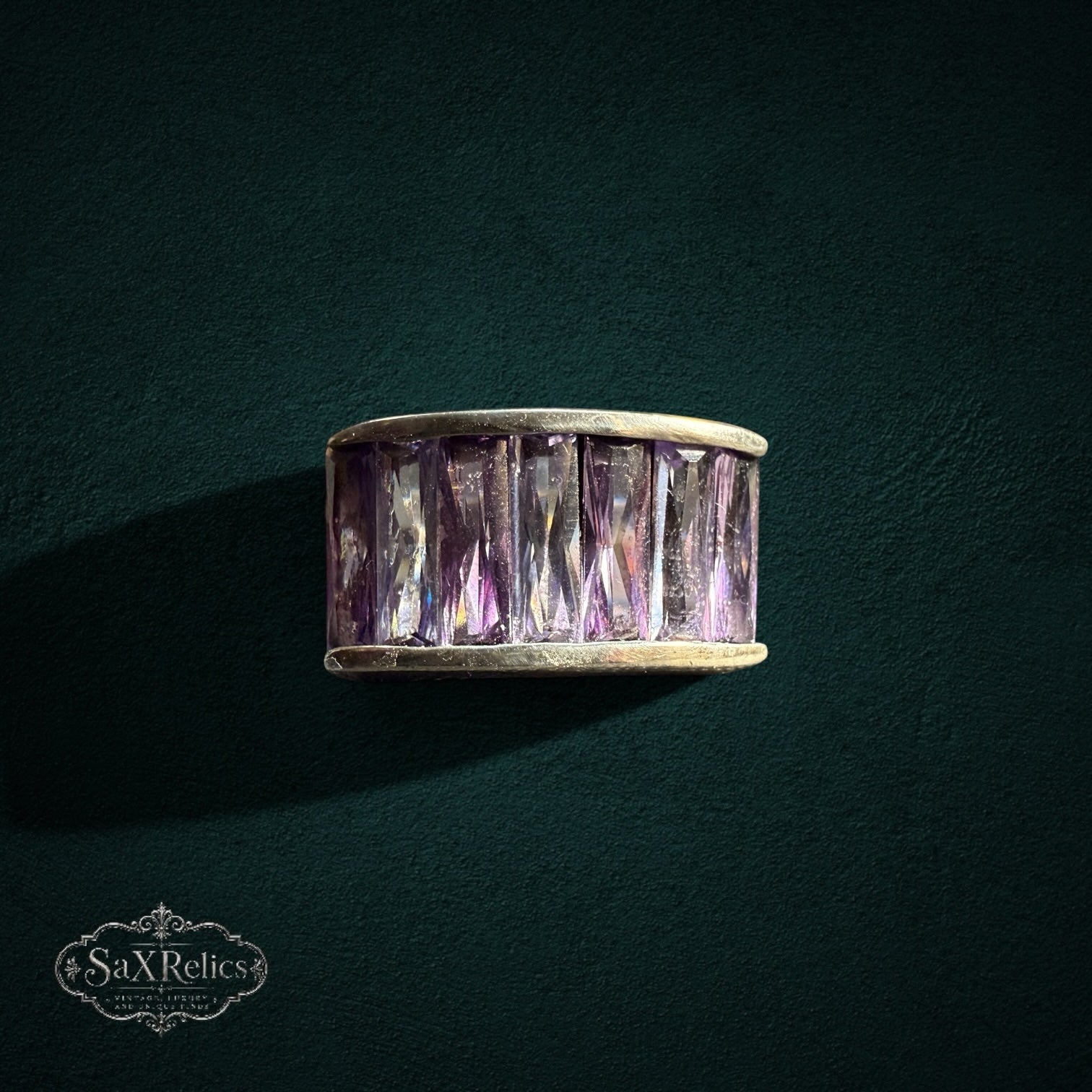 My Store SAXRelics wide band ring featuring baguette-cut purple stones in a polished metal setting.