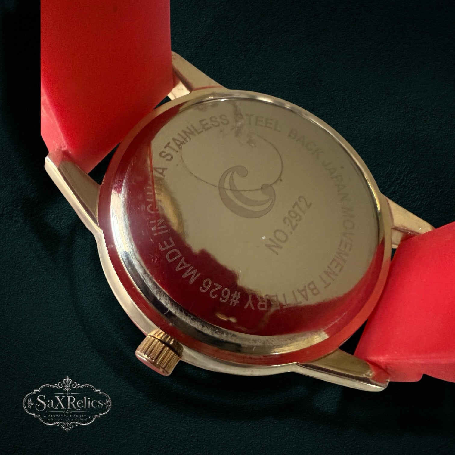 My Store classic analog wristwatch featuring a gold-tone stainless steel case back and a vibrant red silicone strap.