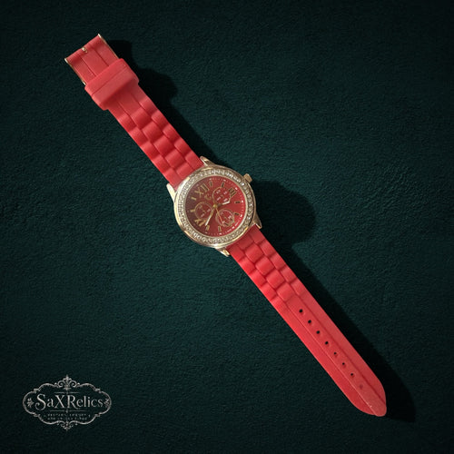My Store red silicone strap watch with gold-tone case, crystal-encrusted bezel, and red dial on dark background
