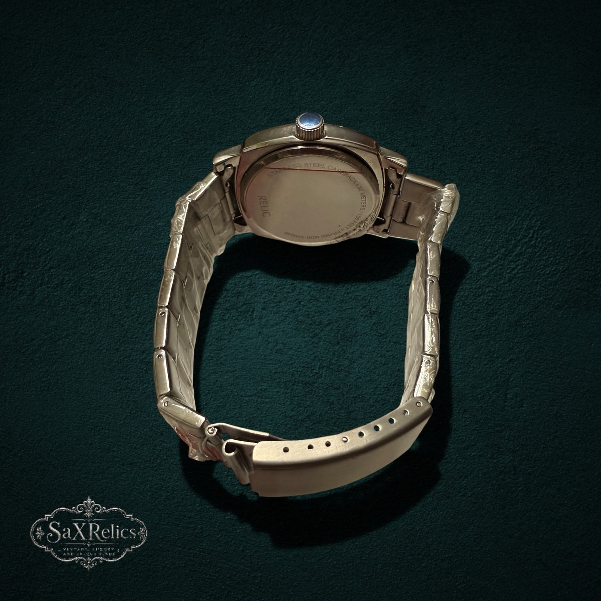 My Store RELIC stainless steel analog wristwatch showing the polished silver-tone case back and link bracelet