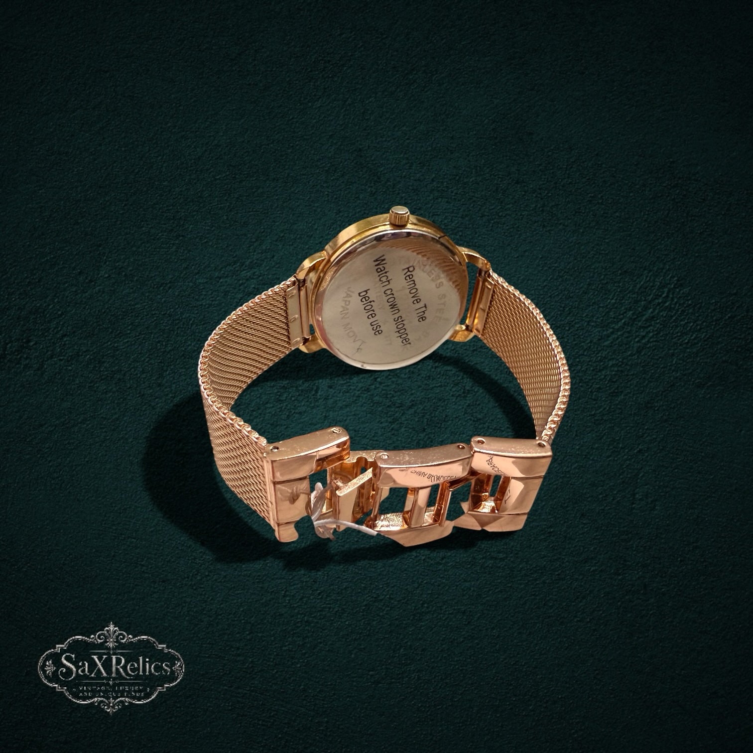My Store rose gold analog watch with adjustable mesh strap and stainless steel back, shown from the rear view.