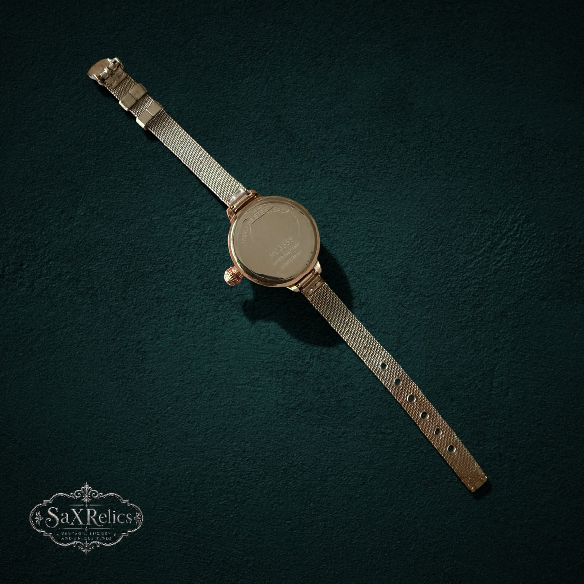 My Store rose gold-tone stainless steel mesh strap wristwatch, back view showing the case and adjustable band.