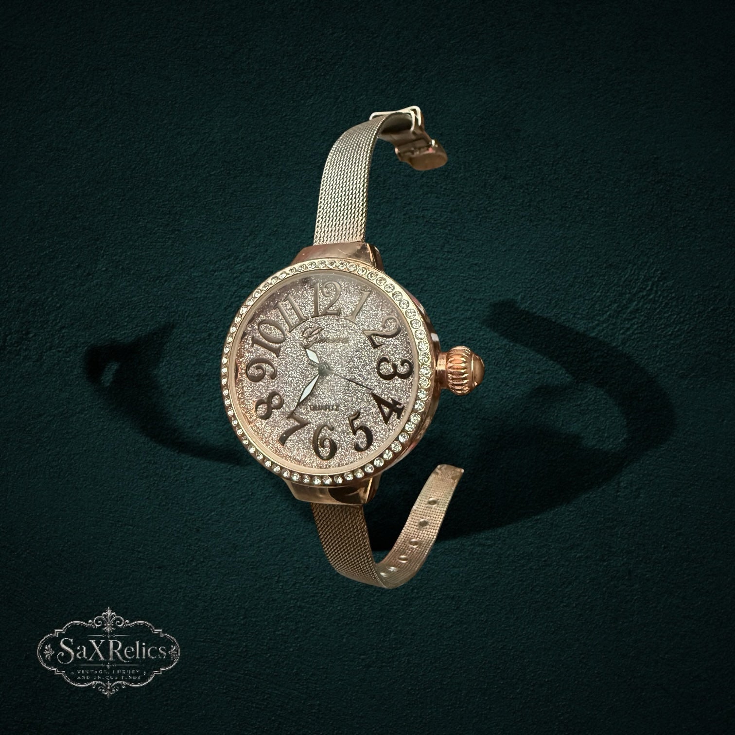 My Store rose gold analog watch with a crystal-encrusted bezel and glitter dial on a stainless steel mesh strap.