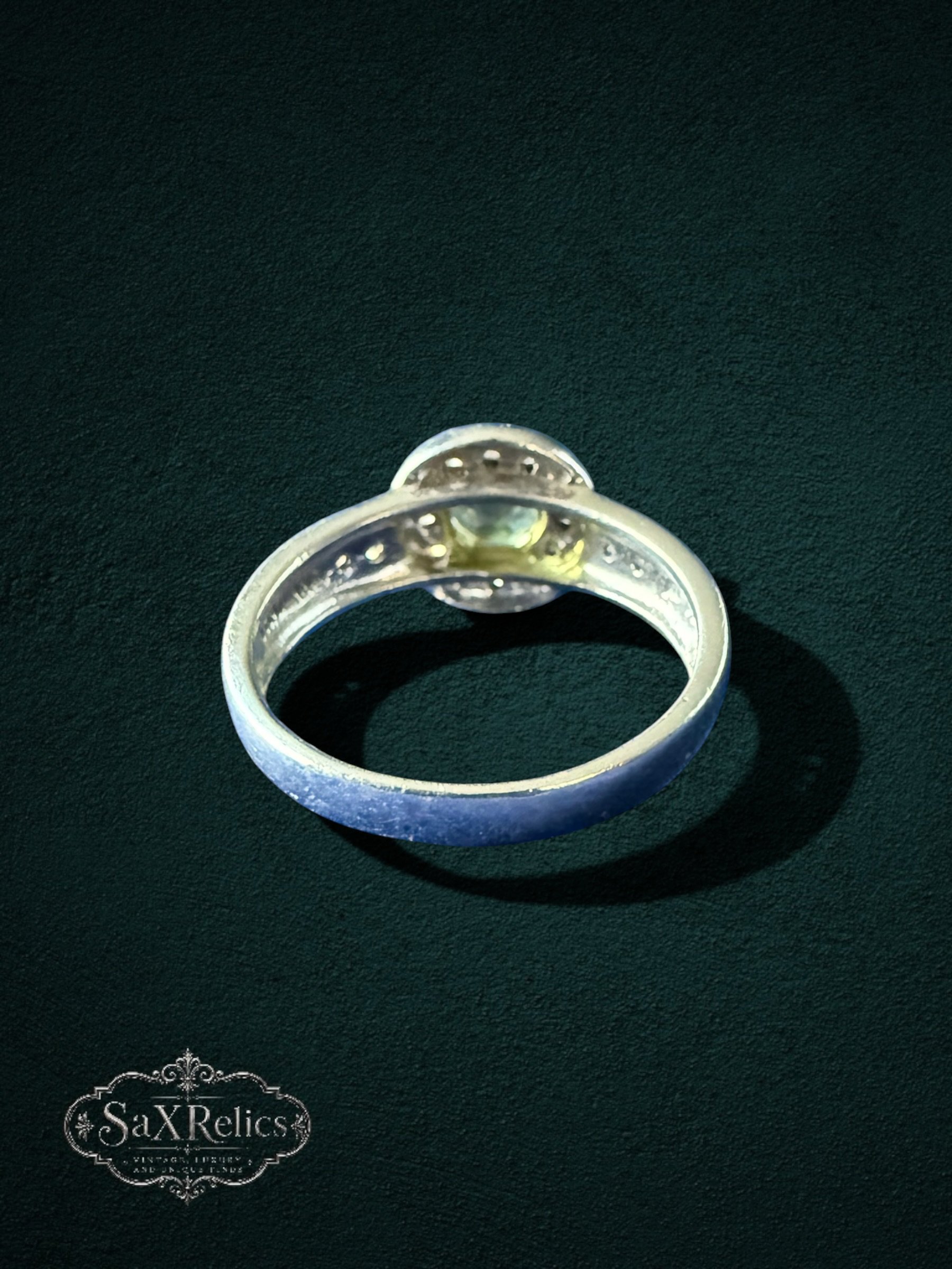 My Store elegant silver-tone halo ring featuring a round-cut yellow-green gemstone with sparkling accent stones.