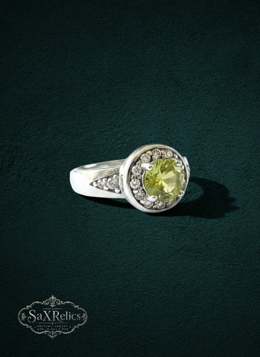 My Store round-cut yellow-green gemstone halo ring in a polished silver-tone setting with accent stones.