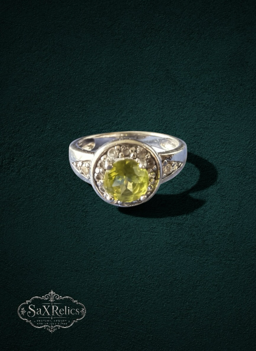My Store round-cut yellow-green gemstone halo ring in a polished silver-tone setting with accent stones.