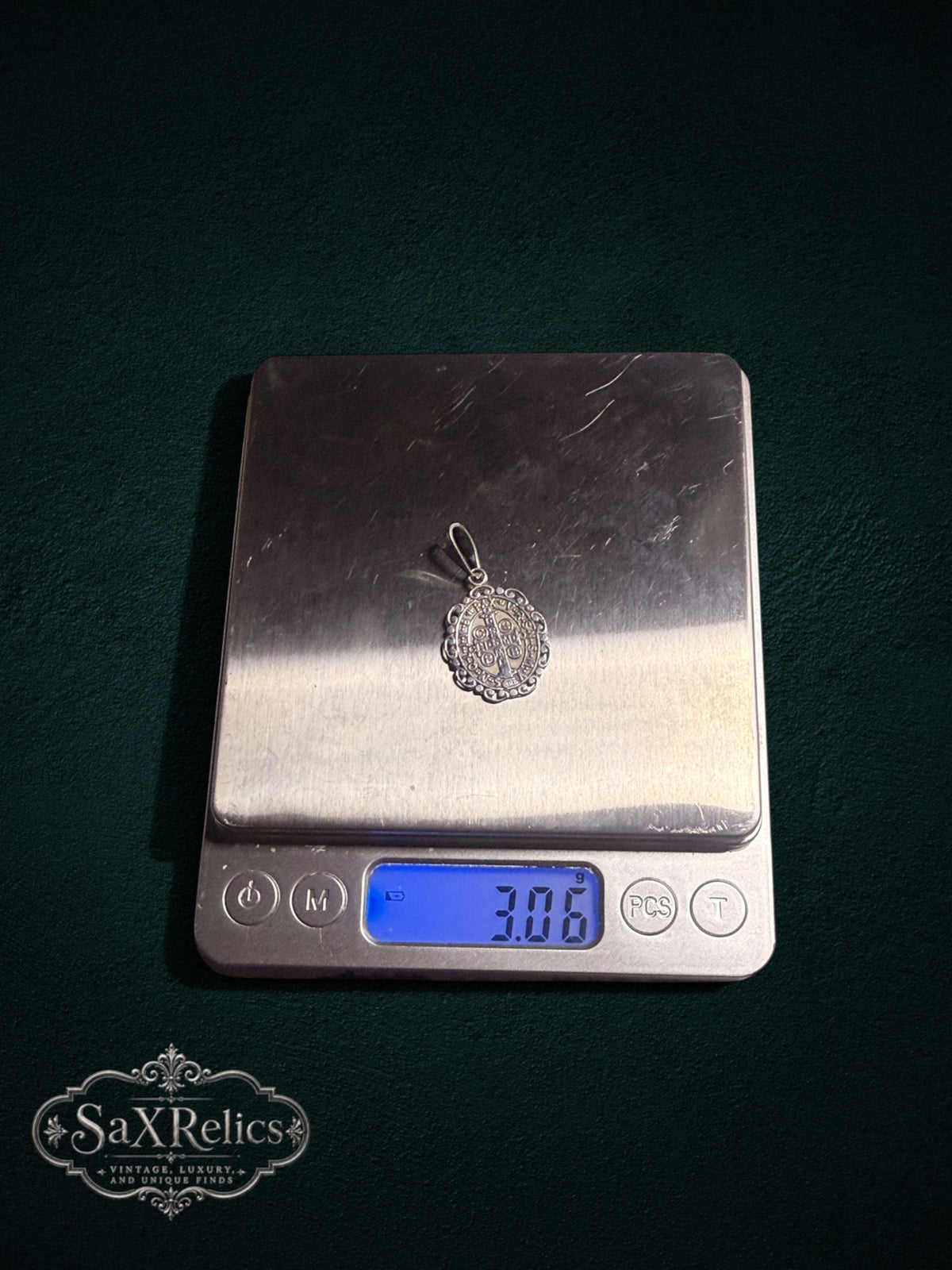 Benito sterling silver Saint Benedict pendant on a digital scale, 3.06 g