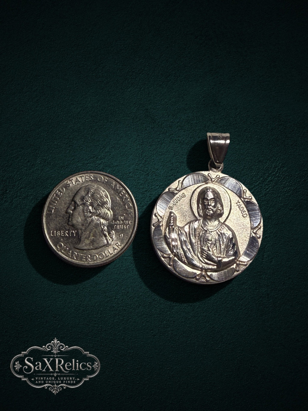 Tadeo sterling silver San Judas medallion next to a US quarter for size