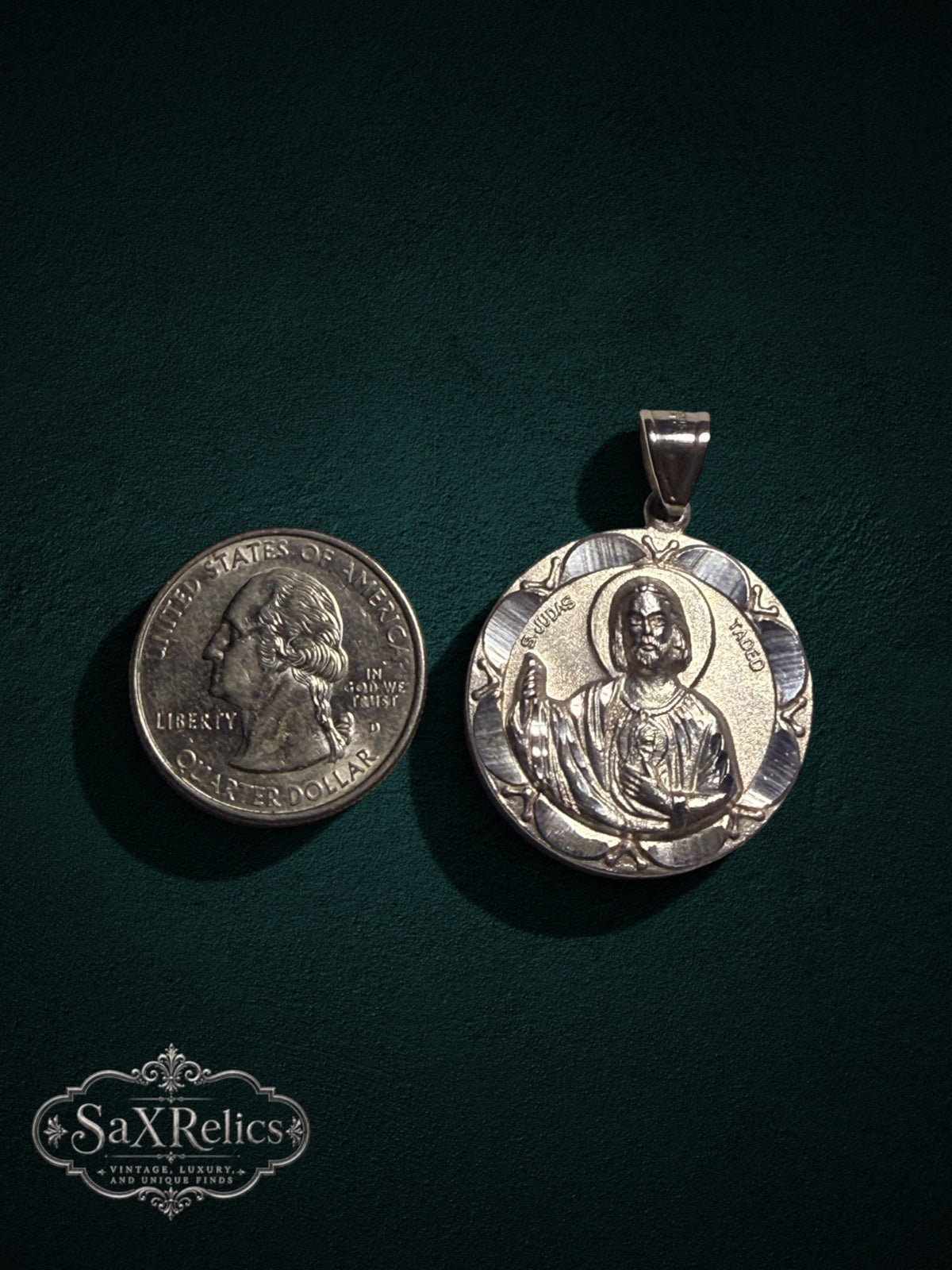 Tadeo sterling silver San Judas medallion next to a US quarter for size