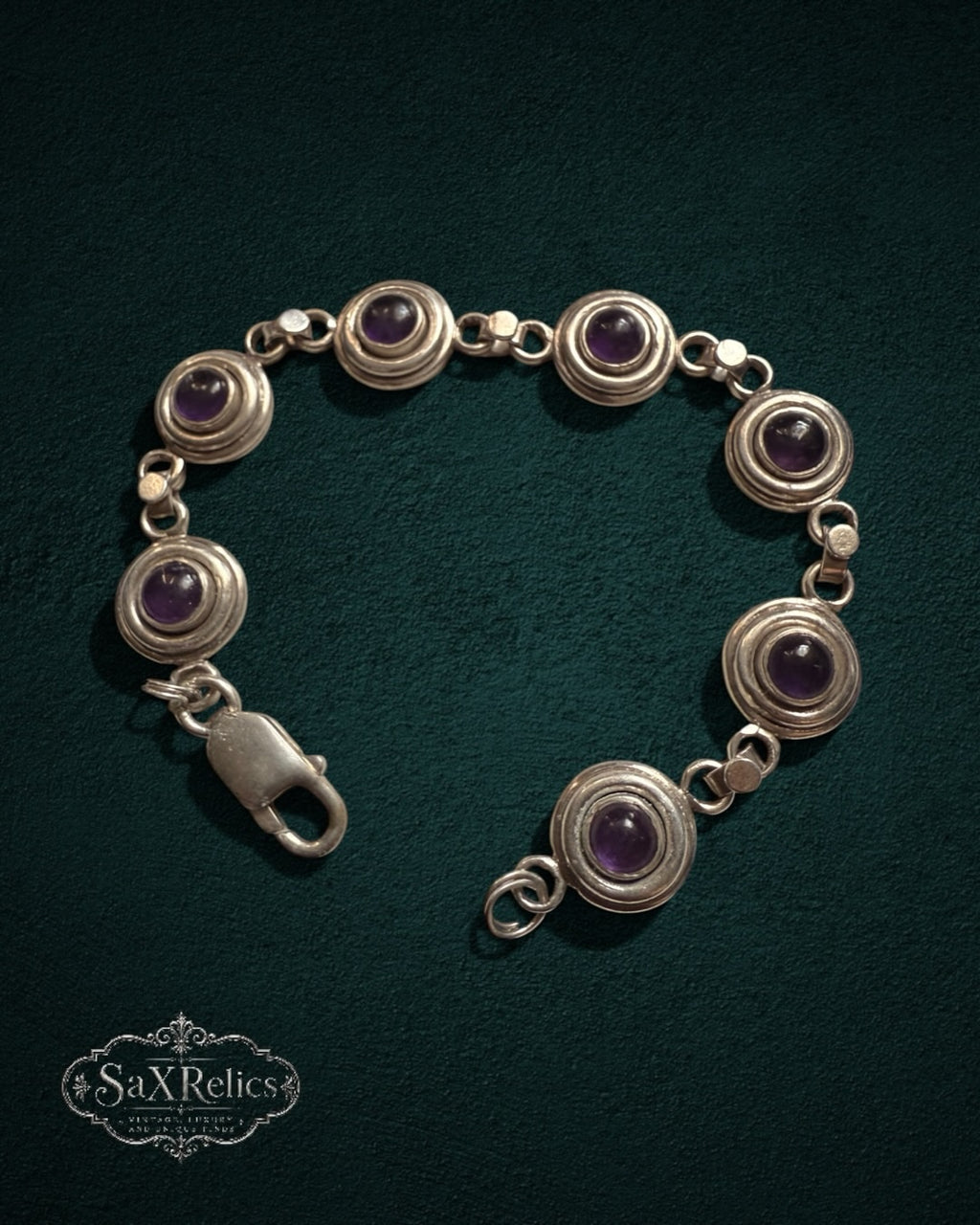 My Store SAXRelics vintage sterling silver link bracelet featuring deep purple amethyst cabochons in circular settings.