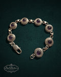 My Store SAXRelics vintage sterling silver link bracelet featuring deep purple amethyst cabochons in circular settings.