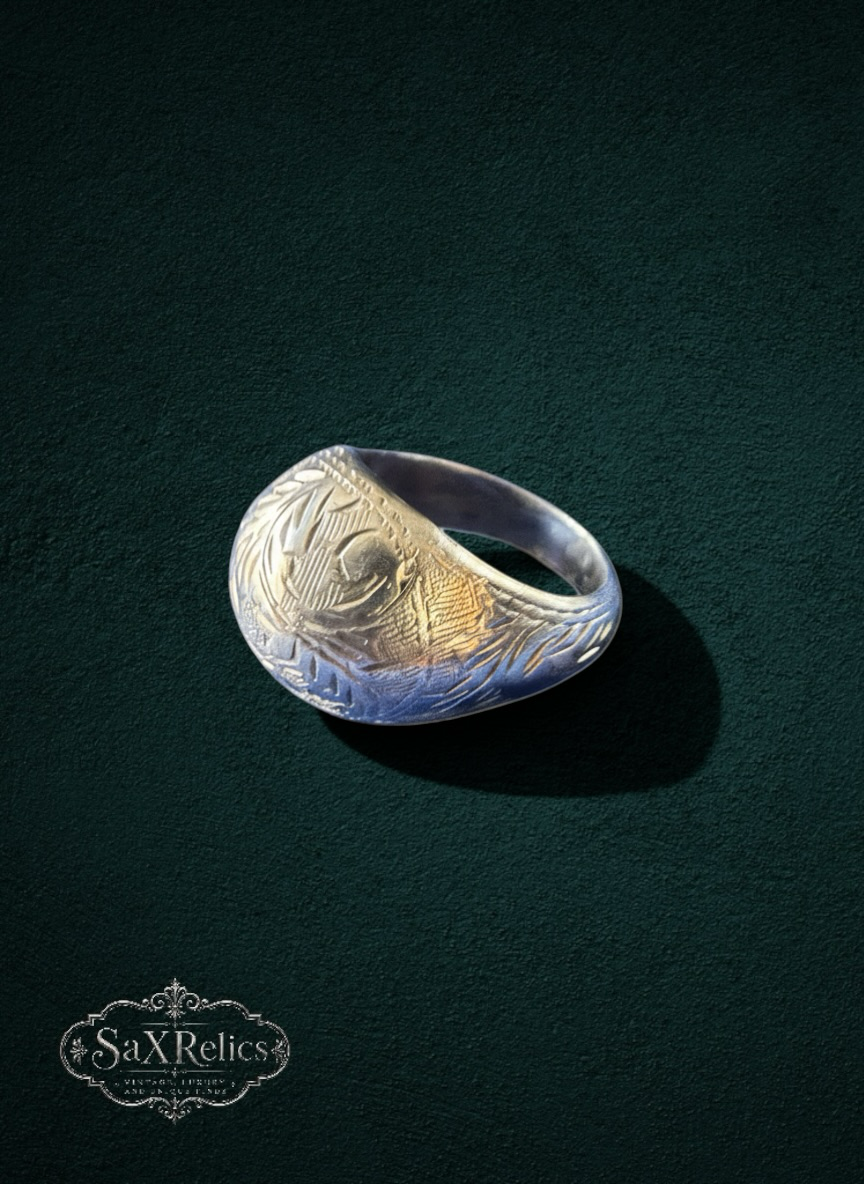 My Store SaXRelics vintage-inspired gold-toned signet ring with intricate botanical engraving on a dark green background