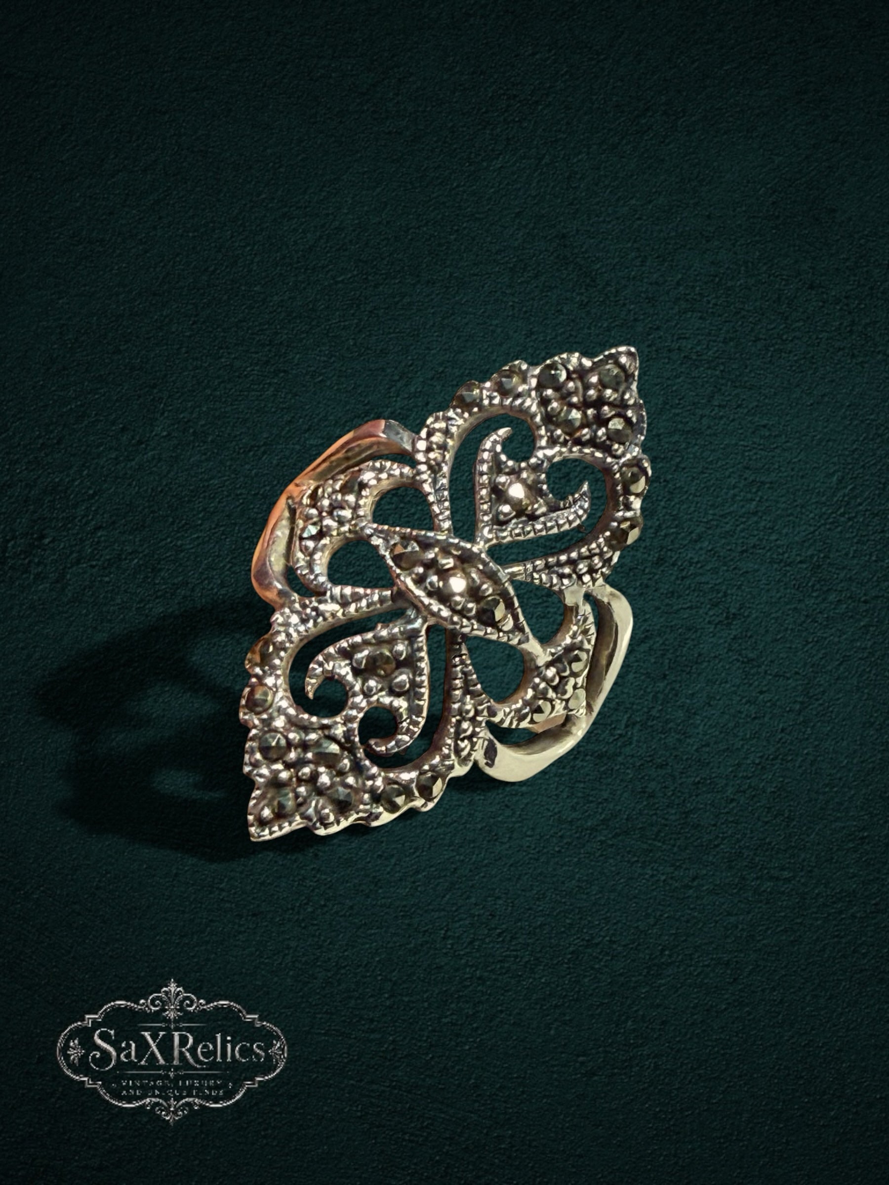 My Store SaxRelics ornate sterling silver statement ring with intricate filigree and shimmering marcasite stones.