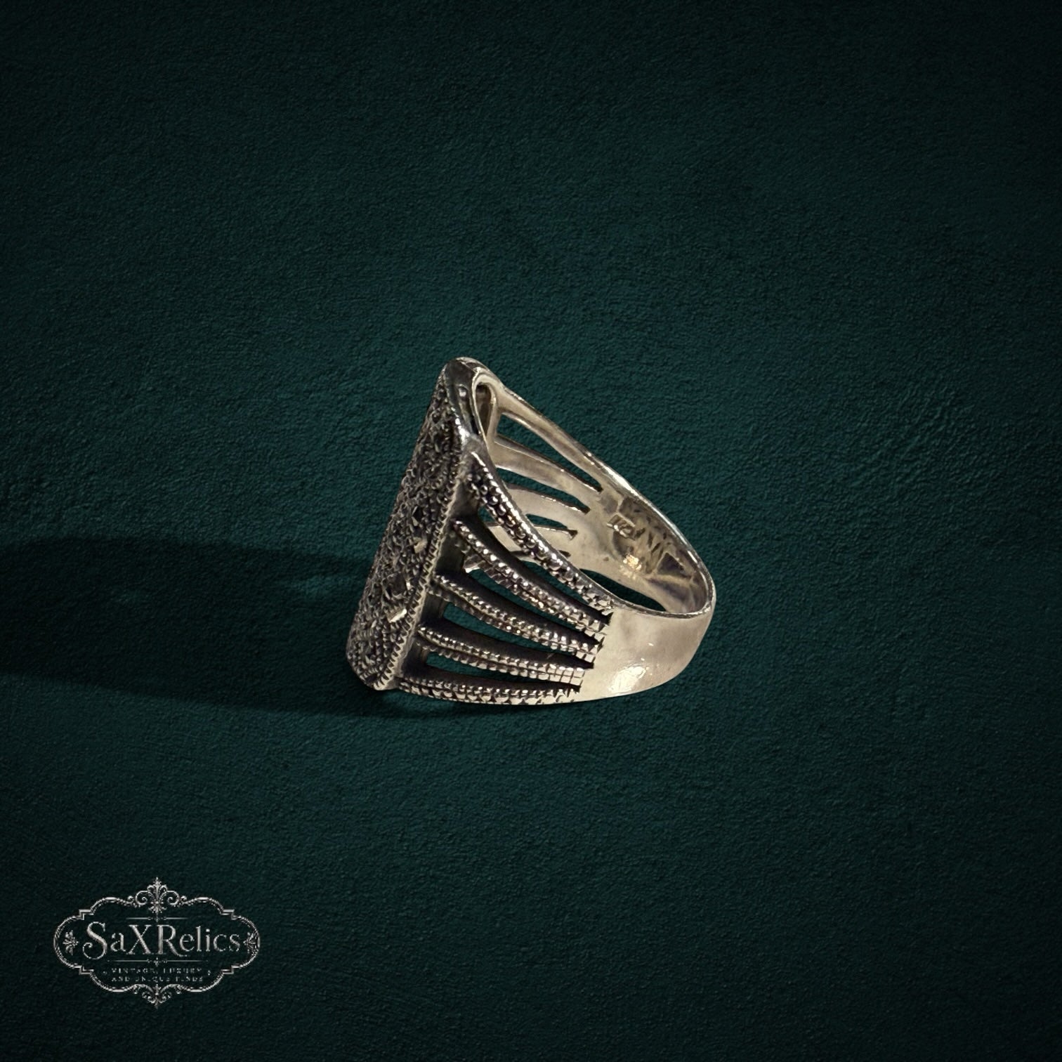 My Store SAXRelics silver statement ring featuring intricate filigree, marcasite stones, and a ribbed architectural band.