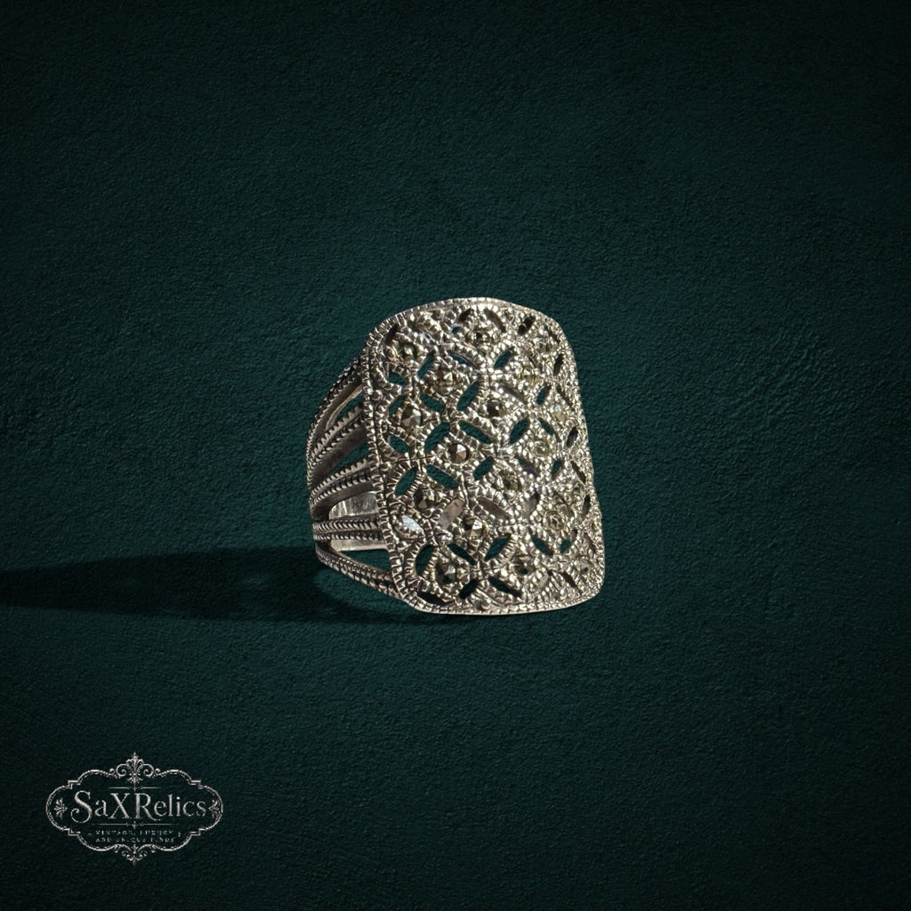 My Store SAXRelics silver-toned statement ring with intricate filigree openwork and shimmering marcasite stone accents.