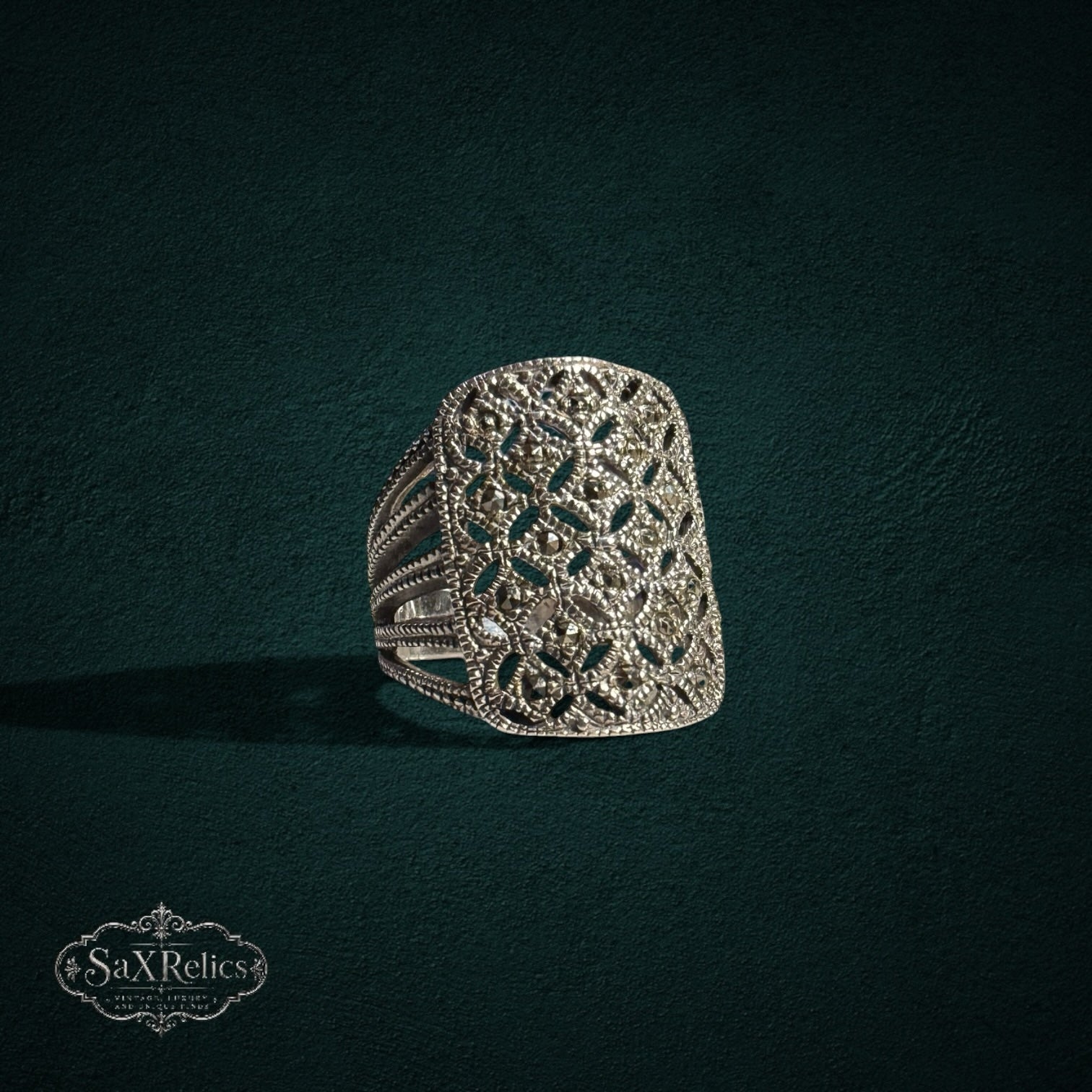 My Store SAXRelics silver-toned statement ring with intricate filigree openwork and shimmering marcasite stone accents.