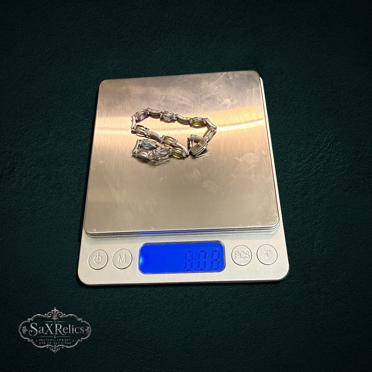 My Store SAXRelics vintage-inspired multi-gemstone link bracelet with oval-cut stones on a digital scale