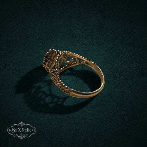 My Store SAXRelics gold-tone ring featuring a pear-cut gemstone, beaded setting, and intricate twisted rope band.