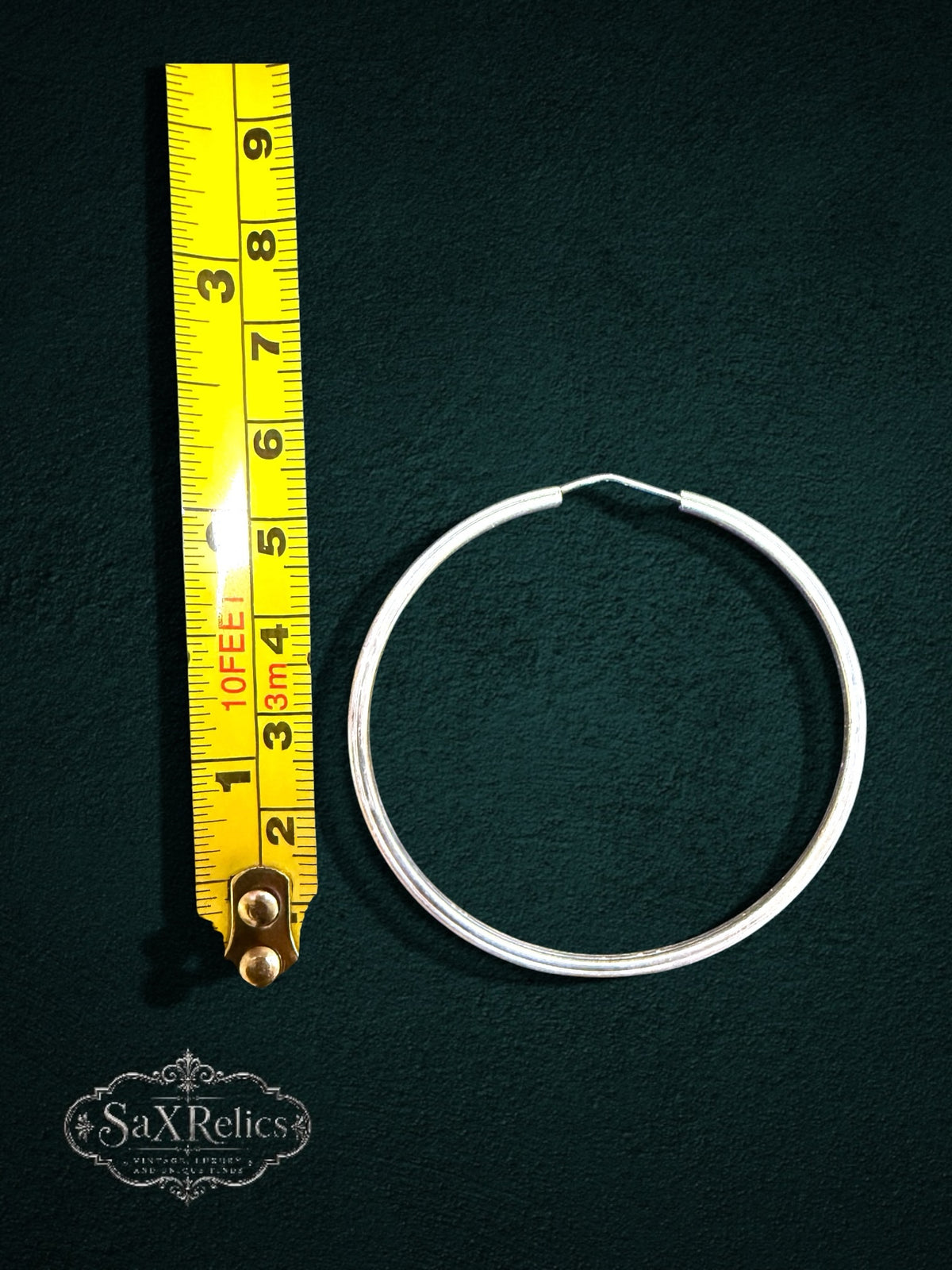 My Store SaxRelics large sterling silver hoop earrings with textured detail shown next to a yellow measuring tape