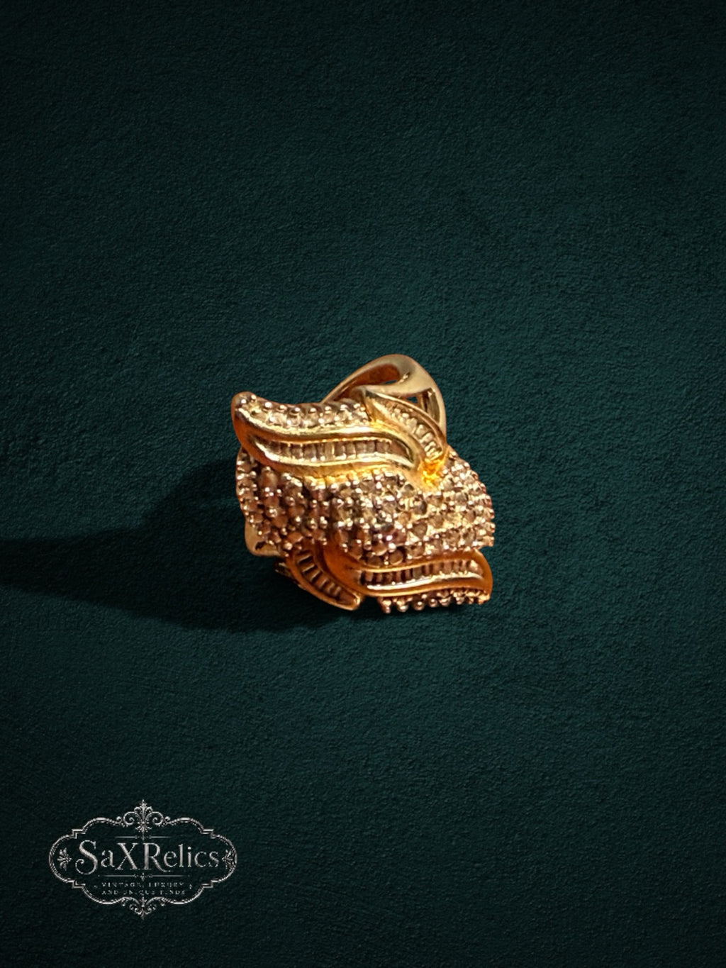 My Store SAXRelics ornate gold statement ring featuring intricate layered textures and brilliant-cut stone accents.