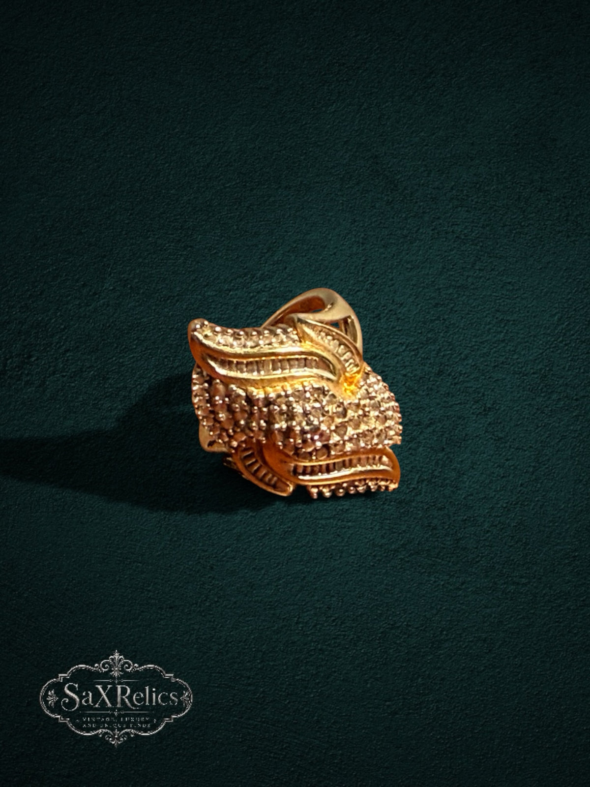 My Store SAXRelics ornate gold statement ring featuring intricate layered textures and brilliant-cut stone accents.