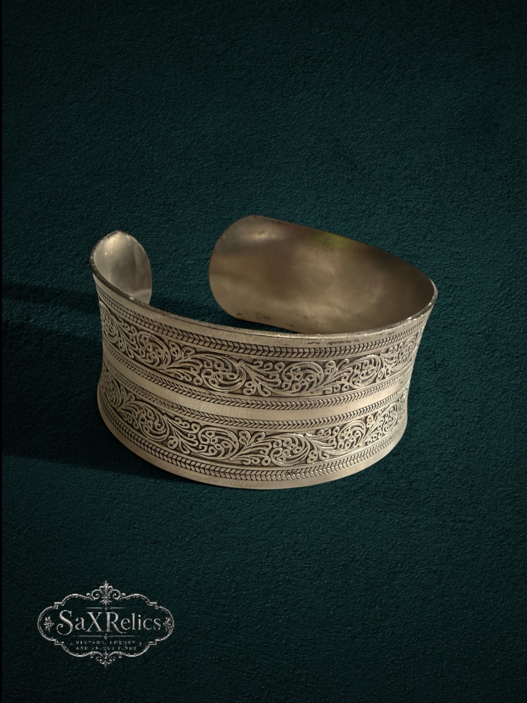 My Store SaXRelics silver wide cuff bracelet with intricate floral engravings and adjustable open-back design.