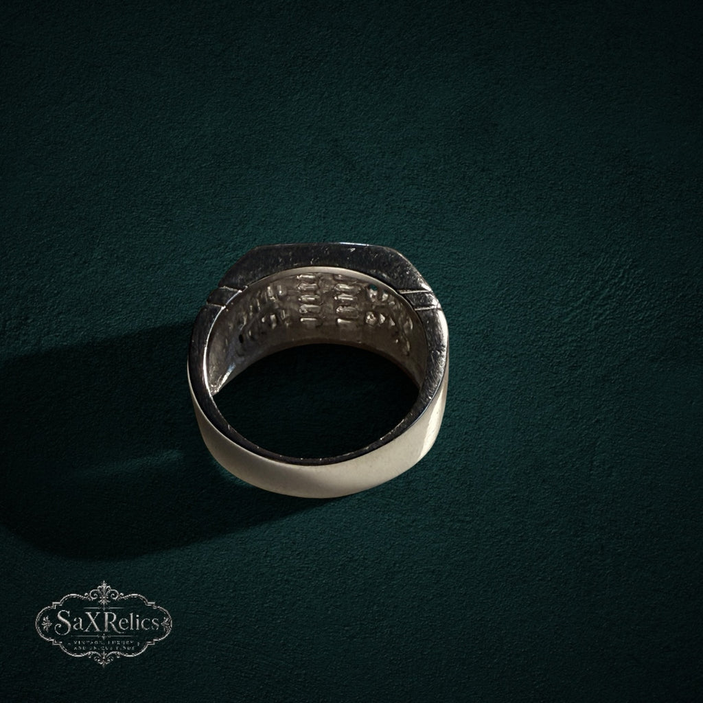 My Store SAXRelics sterling silver statement ring with baguette-cut stones on a dark green textured background
