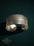 My Store SaXRelics silver wide cuff bracelet with intricate floral engravings and an adjustable open-back design.