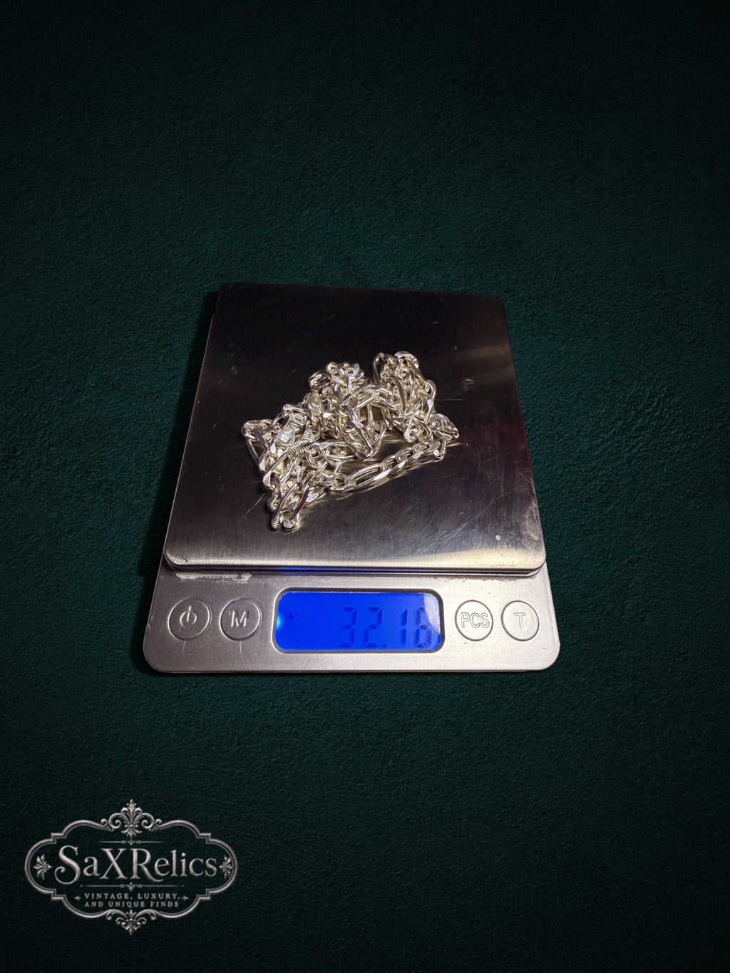 Sevilla sterling silver Figaro chain weighing 32.16 grams on a scale