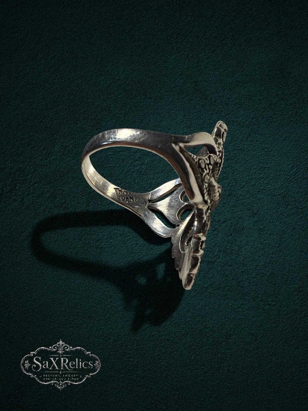 My Store SaxRelics ornate sterling silver statement ring with intricate filigree and marcasite stones, side view.