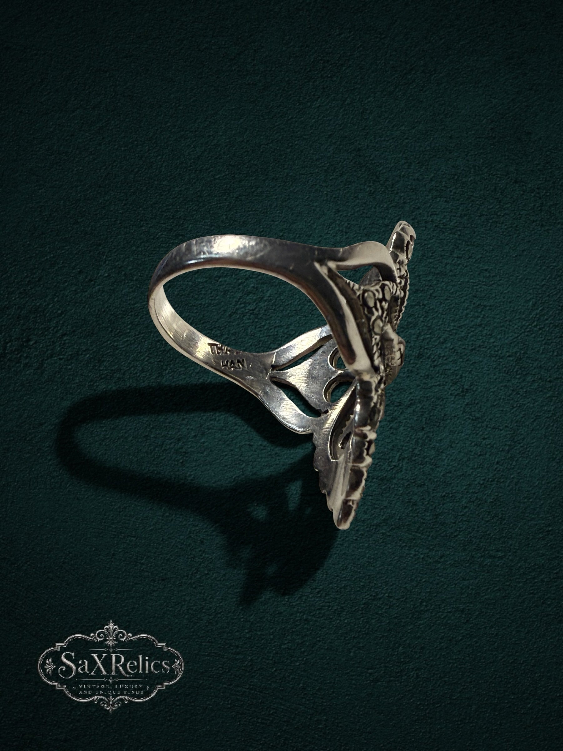 My Store SaxRelics ornate sterling silver statement ring with intricate filigree and marcasite stones, side view.