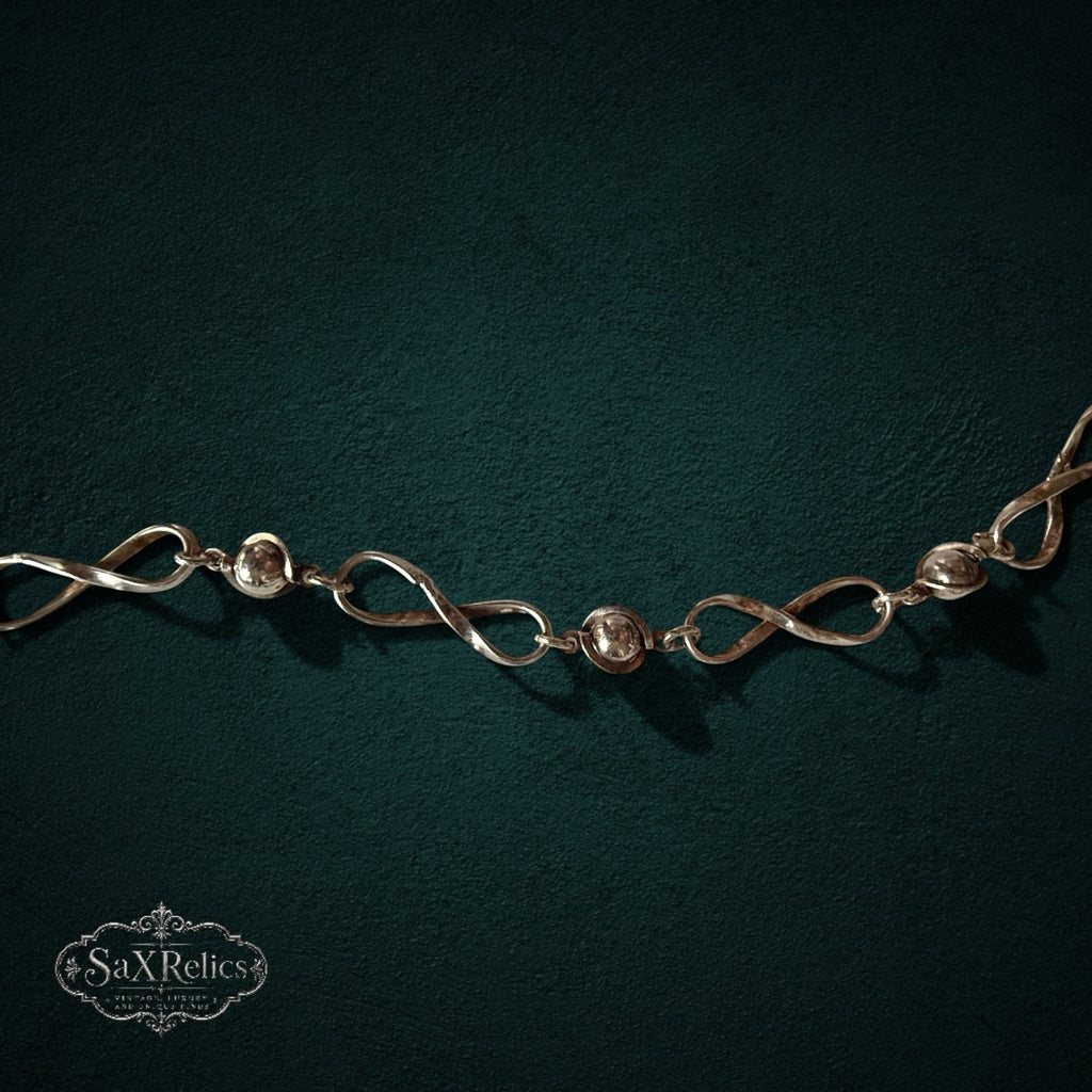 SaX Relics — Infinito sterling silver infinity-link and bead necklace shown full length.