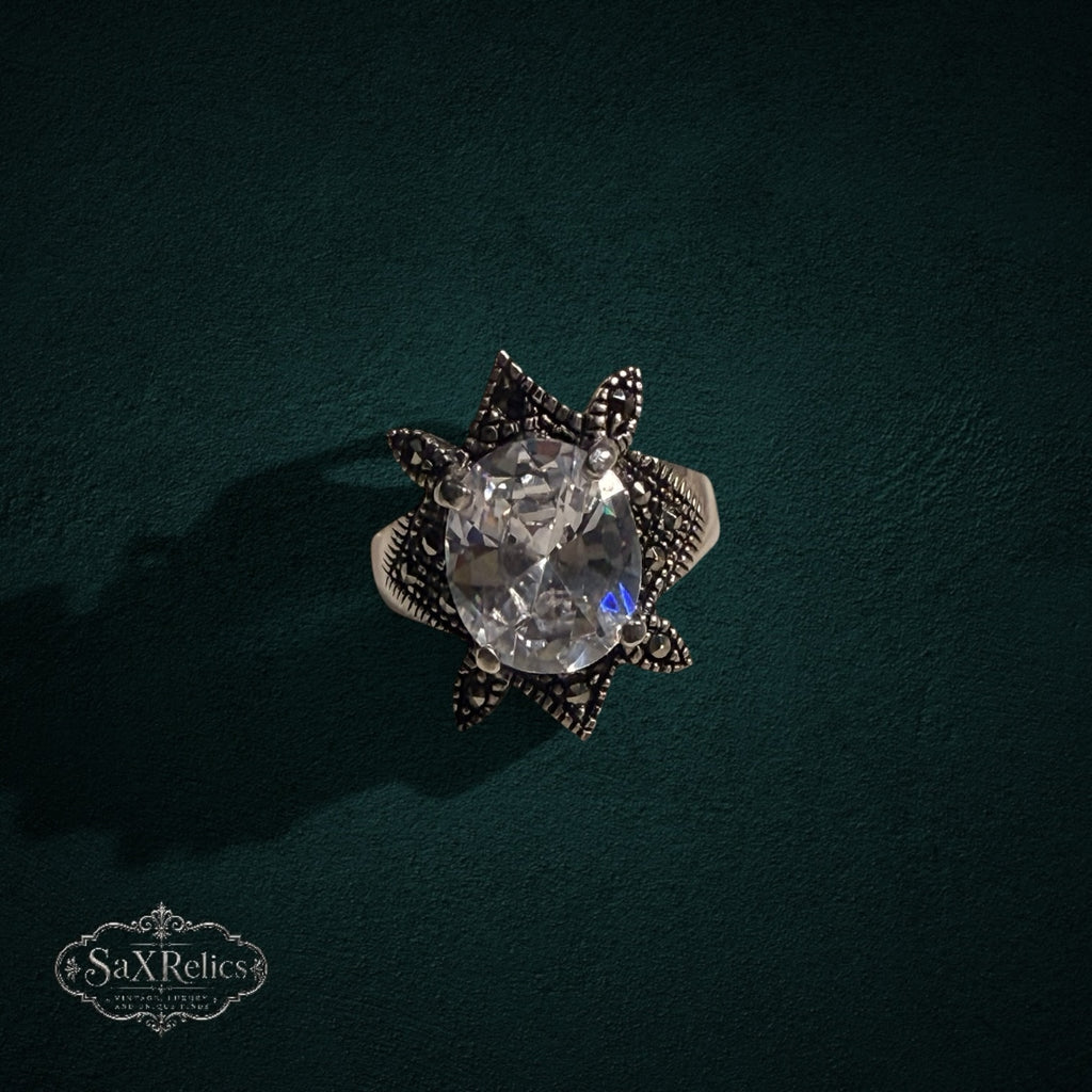 My Store SAXRelics vintage-inspired sterling silver statement ring with an oval clear stone and marcasite star setting.
