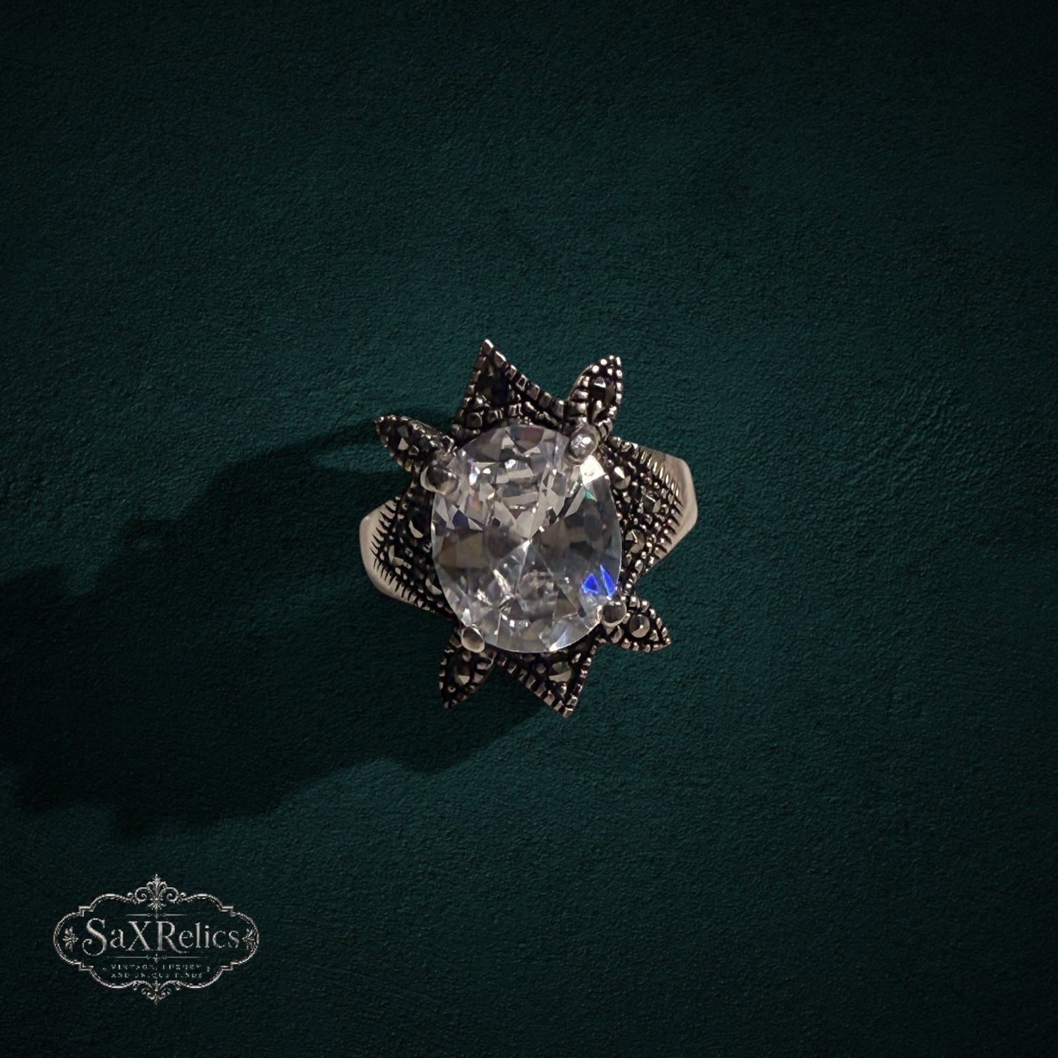 My Store SAXRelics vintage-inspired sterling silver statement ring with an oval clear stone and marcasite star setting.