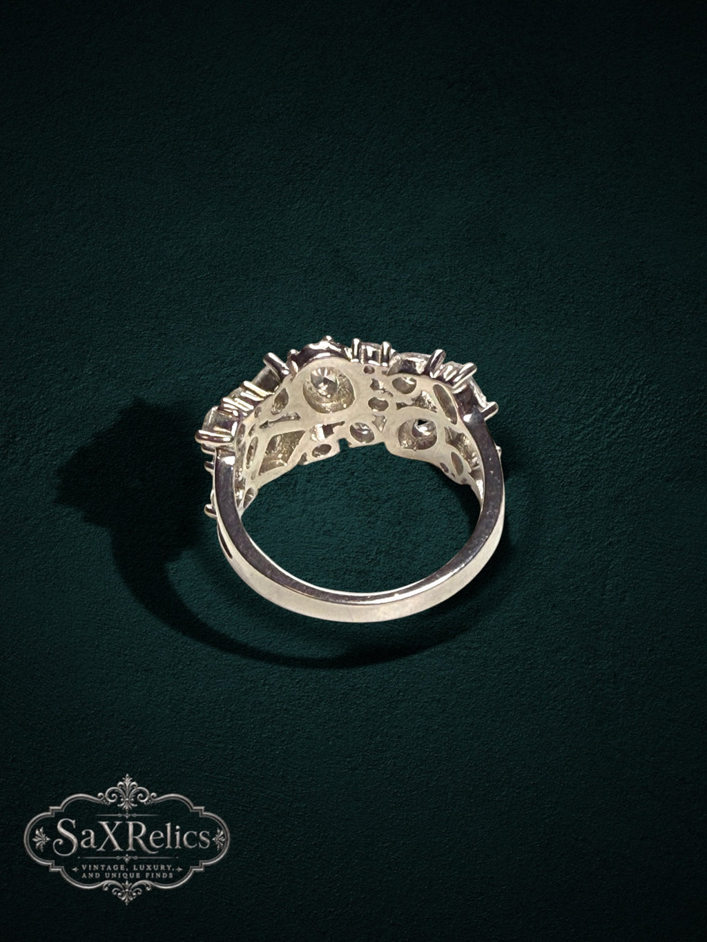 My Store SAXRelics silver-tone statement ring with a cluster of sparkling stones and an intricate split-shank design.