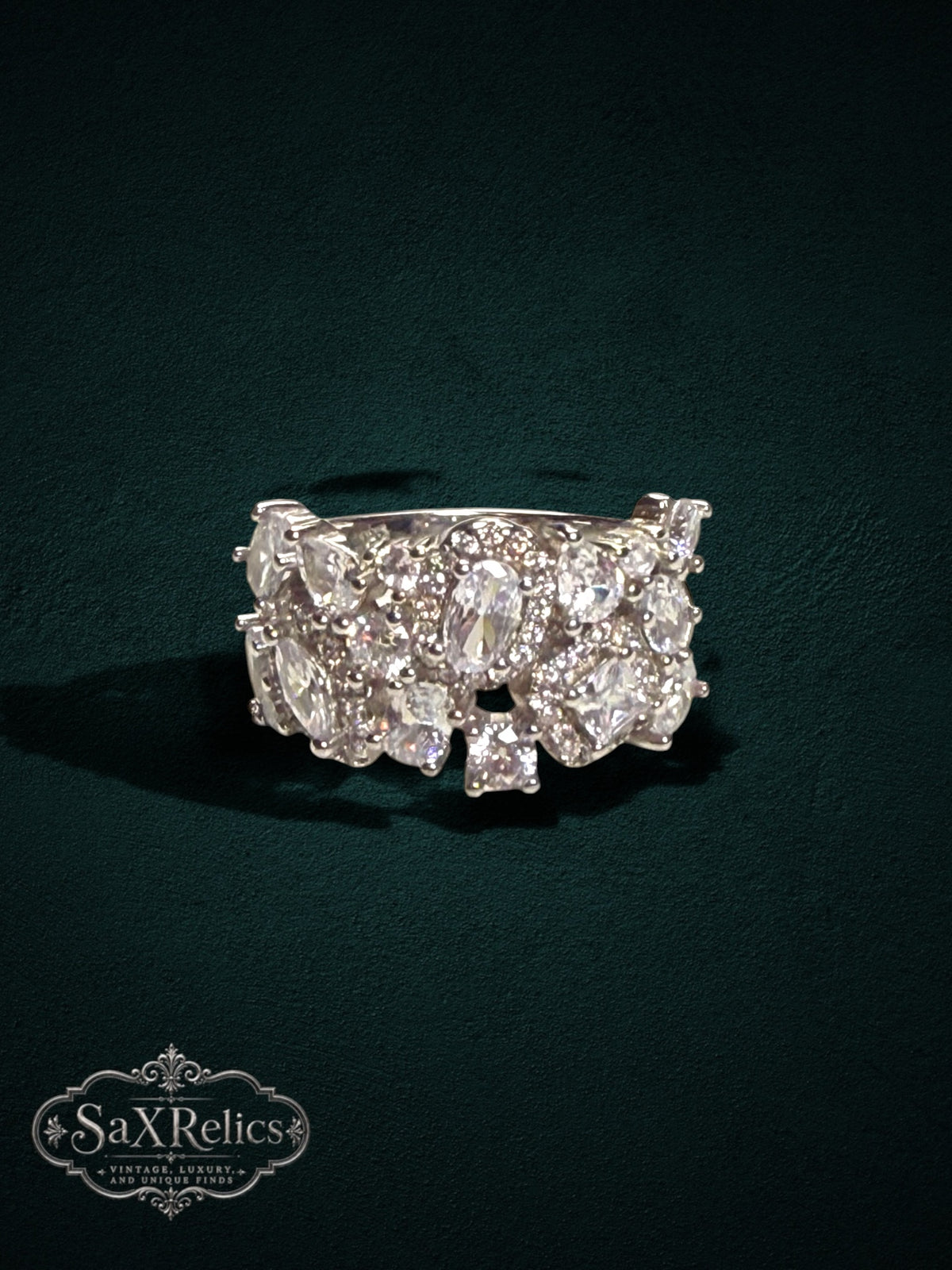 My Store SAXRelics silver-tone statement ring featuring a cluster of sparkling high-clarity stones on a split-shank band
