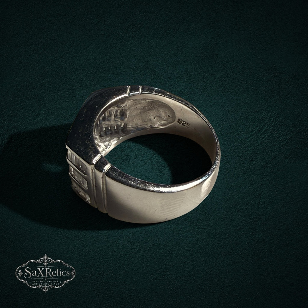 My Store SAXRelics sterling silver statement ring with baguette-cut stones and 925 hallmark on a dark green background